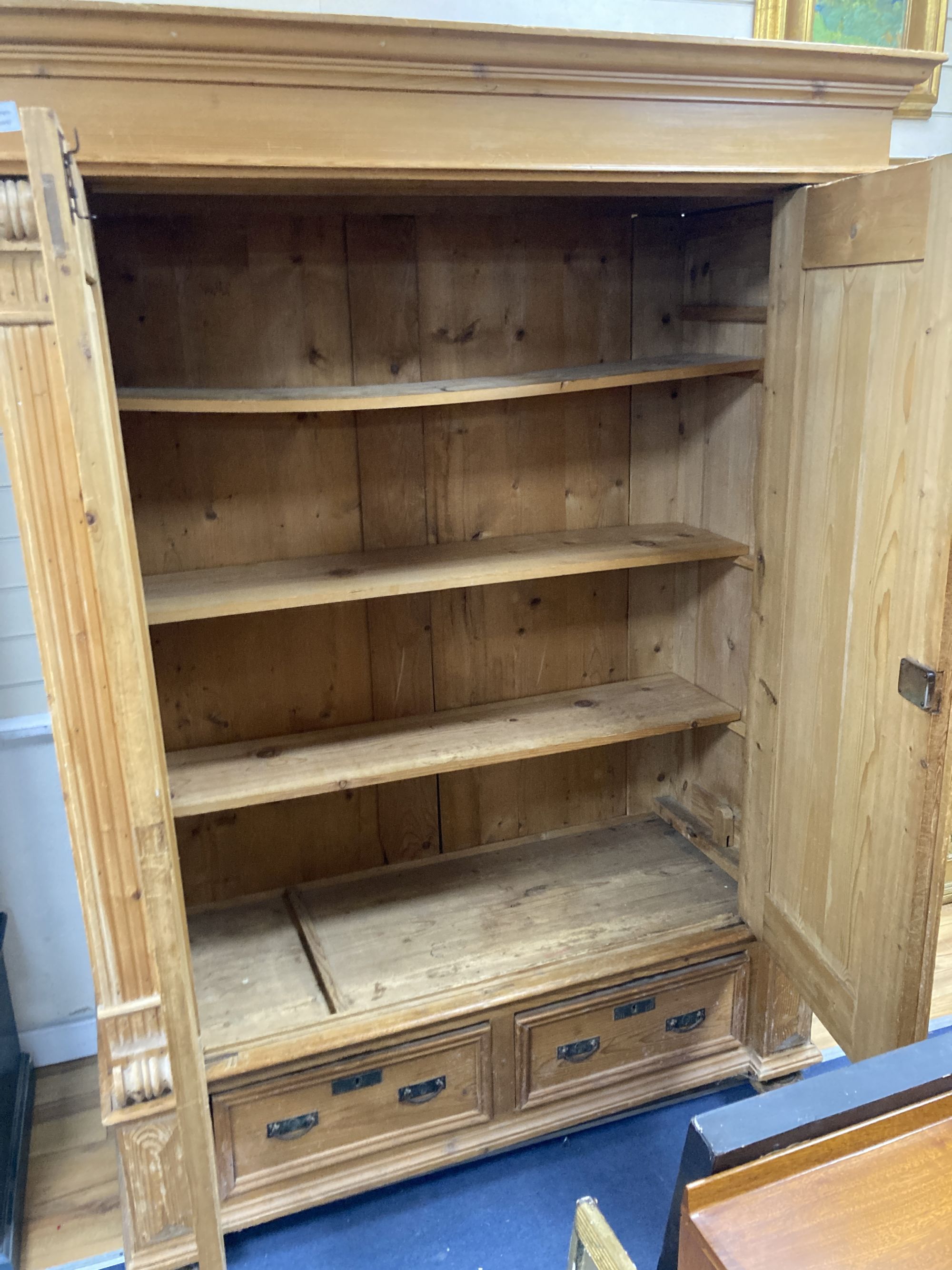 A 19th century East European pine armoire, width 150cm depth 66cm height 203cm